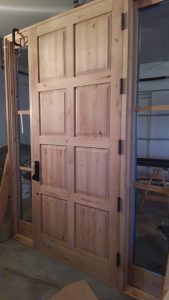 Bronze Entry Door and Sidelites with Knotty Cherry Interiors