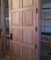 Bronze Entry Door and Sidelites with Knotty Cherry Interiors